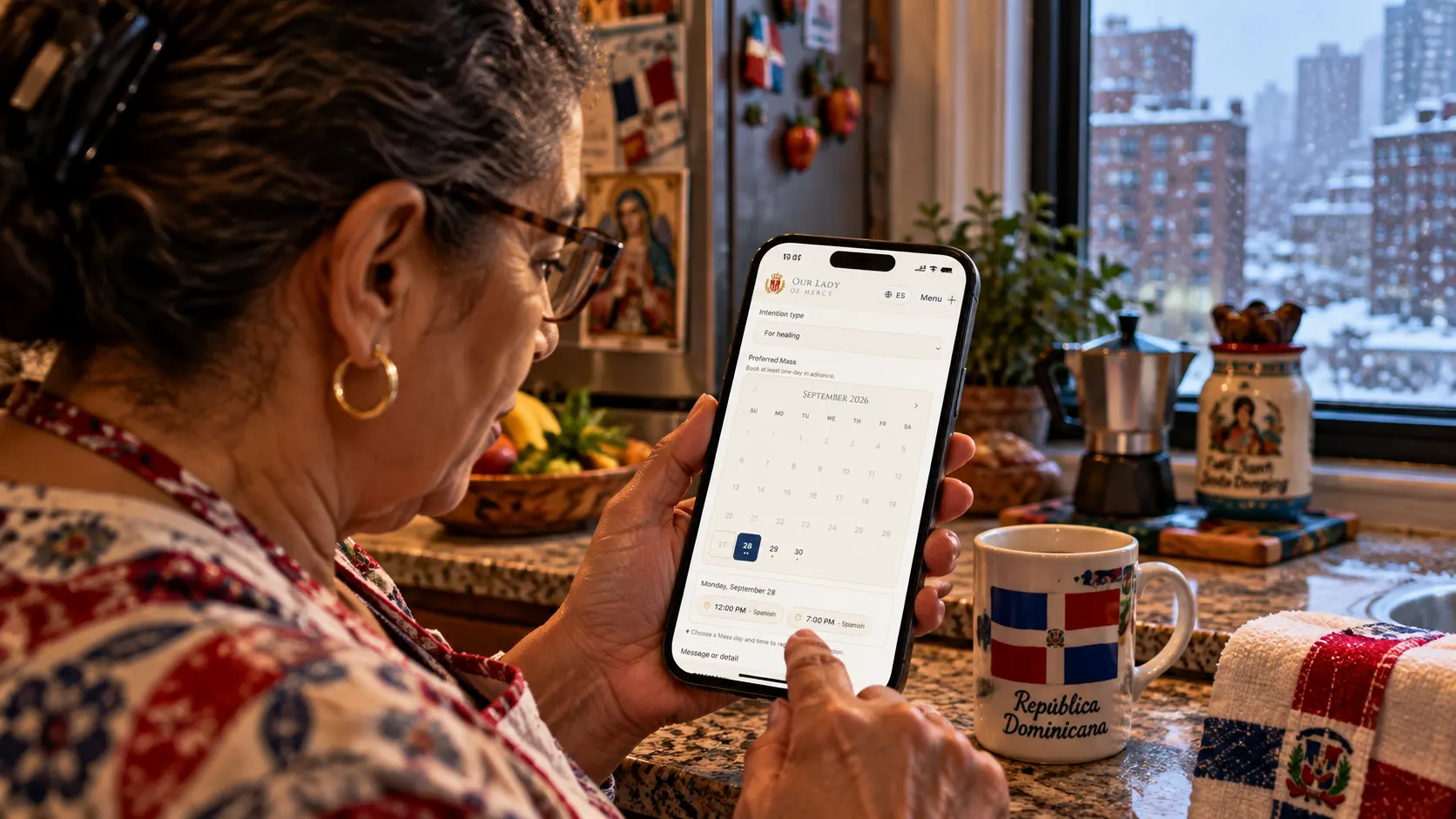 A parishioner in her kitchen at home, with snow outside the window, books a Mass intention on her parish’s website from her phone.